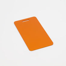 Load image into Gallery viewer, Orange, ready-to-machine anodized aluminum luggage tags for your next CNC project.
